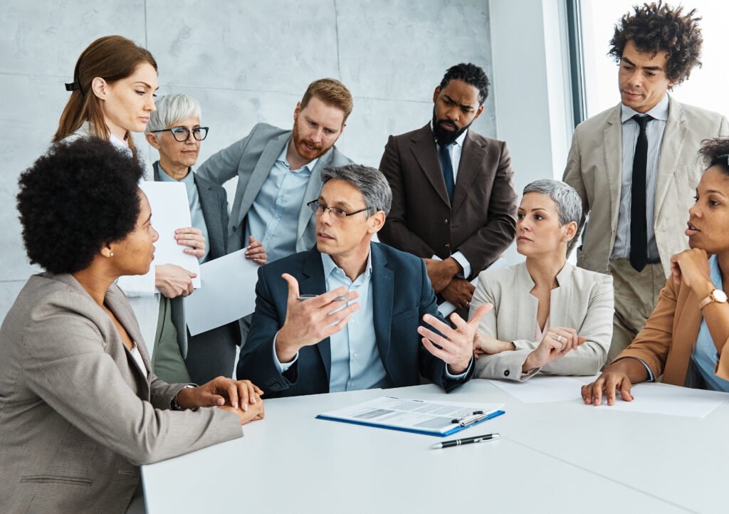 Leadership coaching session with executives and team members discussing strategies